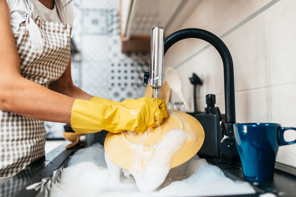 washing dishes in soapy sink